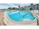 Community pool area with clear blue water, palm trees and white picket fence at 1868 Shore S Dr # 410, South Pasadena, FL 33707