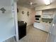 Efficient kitchen with white cabinets and built-in microwave at 2426 Persian Dr # 64, Clearwater, FL 33763