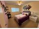 Bedroom with a double bed, nightstands, and wall art at 2426 Persian Dr # 64, Clearwater, FL 33763