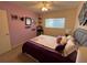 Bright bedroom with a queen-size bed and purple bedding at 2426 Persian Dr # 64, Clearwater, FL 33763