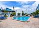 Community pool with lounge chairs and patio area at 171 Medallion Blvd # H, Madeira Beach, FL 33708