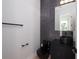 Modern powder room featuring dark marble accents, black fixtures, and a sleek design at 1002 W Charter St, Tampa, FL 33602