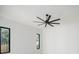 Bedroom with large ceiling fan, hardwood floors, and black window frames at 1002 W Charter St, Tampa, FL 33602