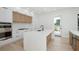 Bright modern kitchen with stainless steel appliances, a spacious island, and wood grain accents at 1002 W Charter St, Tampa, FL 33602