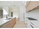 Beautiful kitchen featuring a large island, modern appliances, and ample cabinet space with a view to the hallway at 1002 W Charter St, Tampa, FL 33602