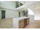 Open-concept living room with soaring ceilings, modern lighting, hardwood floors, and a custom wine fridge at 1002 W Charter St, Tampa, FL 33602