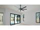 Main bedroom features large sliding glass doors providing pool views, hardwood floors, and black window frames at 1002 W Charter St, Tampa, FL 33602