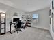 Home office with a standing desk, black chair, and plenty of shelving at 9509 Lamine Way, Parrish, FL 34219