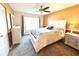 Bright bedroom with a queen-size bed, ample closet space, and a ceiling fan at 4529 Whitton Way # 223, New Port Richey, FL 34653