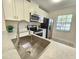 Modern kitchen with stainless steel appliances and quartz countertops at 1701 Pinehurst Rd # 26E, Dunedin, FL 34698