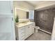 Updated bathroom with white vanity, large mirror, and grey tile shower at 1701 Pinehurst Rd # 26E, Dunedin, FL 34698