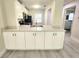 Modern kitchen with white cabinets, stainless steel appliances, and a breakfast bar at 1701 Pinehurst Rd # 26E, Dunedin, FL 34698