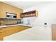 Modern kitchen with bamboo cabinets and concrete countertops at 7740 Boca Ciega Dr # 209, St Pete Beach, FL 33706