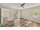 Bedroom with wood-look floors and access to a porch at 402 Lake Point Ct # D, Sun City Center, FL 33573