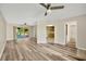 Open concept living room with laminate flooring and views of kitchen and patio at 402 Lake Point Ct # D, Sun City Center, FL 33573