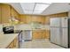 Kitchen boasts stainless steel appliances and wood cabinets at 402 Lake Point Ct # D, Sun City Center, FL 33573