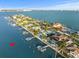 Beautiful waterfront homes with private docks line the bay in this scenic aerial view, showcasing the serene coastal lifestyle at 505 55Th Ave, St Pete Beach, FL 33706