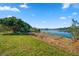 Scenic lake view with large tree and grassy area at 2850 Sunstream Ln, Clearwater, FL 33759