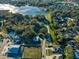 Aerial view of a vacant lot near a lake and other homes at 2850 Sunstream Ln, Clearwater, FL 33759