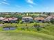 Spacious home overlooking a pond and lush greenery creating a serene and private backyard setting at 898 Skye Ln, Palm Harbor, FL 34683