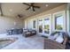 Relaxing covered patio with comfortable seating and a dining area overlooking the pool and landscaped backyard at 898 Skye Ln, Palm Harbor, FL 34683