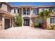 Elegant two-story home with a beautiful entryway, brick driveway, and well-maintained landscaping at 898 Skye Ln, Palm Harbor, FL 34683