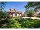 Lush front yard with manicured landscaping complementing the home's exterior and brick driveway at 898 Skye Ln, Palm Harbor, FL 34683