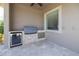 Outdoor kitchen features a built-in grill, sink, refrigerator, and travertine tile at 898 Skye Ln, Palm Harbor, FL 34683