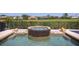 Luxury pool and spa with natural stone accents and a beautifully landscaped backyard with a fence at 898 Skye Ln, Palm Harbor, FL 34683