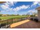 Private patio overlooking golf course with tile flooring and seating area at 898 Skye Ln, Palm Harbor, FL 34683