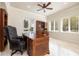 Bright home office features built-in shelving, large windows, and hardwood floors at 898 Skye Ln, Palm Harbor, FL 34683