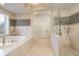 Large bathroom with soaking tub, walk in shower, and double vanity at 898 Skye Ln, Palm Harbor, FL 34683