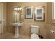 Simple bathroom with pedestal sink, toilet, and tiled walls at 898 Skye Ln, Palm Harbor, FL 34683