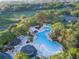 Large resort-style pool with plenty of lounge chairs at 898 Skye Ln, Palm Harbor, FL 34683