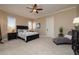 Spacious bedroom with carpeted floor, ceiling fan, and ample closet space at 898 Skye Ln, Palm Harbor, FL 34683