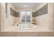 Jetted tub and mosaic tile detail in this spa-like bathroom at 898 Skye Ln, Palm Harbor, FL 34683