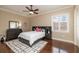 Bright bedroom with hardwood floors, ceiling fan, and built-in shelving at 898 Skye Ln, Palm Harbor, FL 34683