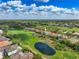 Luxury home situated on a golf course with a pond nearby, showcasing its prime location at 898 Skye Ln, Palm Harbor, FL 34683
