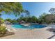 Relaxing pool area with lounge chairs and umbrellas at 898 Skye Ln, Palm Harbor, FL 34683