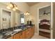 Double vanity bathroom with granite countertops and access to bedroom at 898 Skye Ln, Palm Harbor, FL 34683