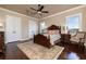 Bedroom with hardwood floors, large bed, and ornate wood furniture at 898 Skye Ln, Palm Harbor, FL 34683