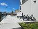 Modern pool and patio area with lounge chairs and water access at 211 Dolphin Pt # 303, Clearwater, FL 33767