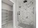 Modern bathroom with walk-in shower and shelving at 211 Dolphin Pt # 303, Clearwater, FL 33767