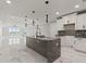 Open kitchen with large island and marble flooring at 211 Dolphin Pt # 303, Clearwater, FL 33767