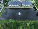 Townhouses reflected in a calm lake with a central fountain at 7660 93Rd N St, Seminole, FL 33777