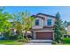 Two-story home with a two-car garage and landscaping at 12874 Burns Dr, Odessa, FL 33556
