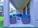 Covered patio with wicker furniture and a grill at 12874 Burns Dr, Odessa, FL 33556