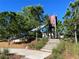Modern playground with slide, climbing structures, and wood chips at 12874 Burns Dr, Odessa, FL 33556
