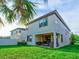 Two story house with covered patio and grassy backyard at 12874 Burns Dr, Odessa, FL 33556