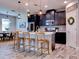 Modern kitchen with dark cabinetry, stainless steel appliances, and an island at 12874 Burns Dr, Odessa, FL 33556